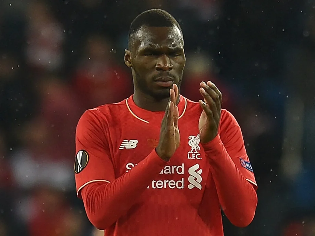 Liverpool forward Christian Benteke is clapping during a match